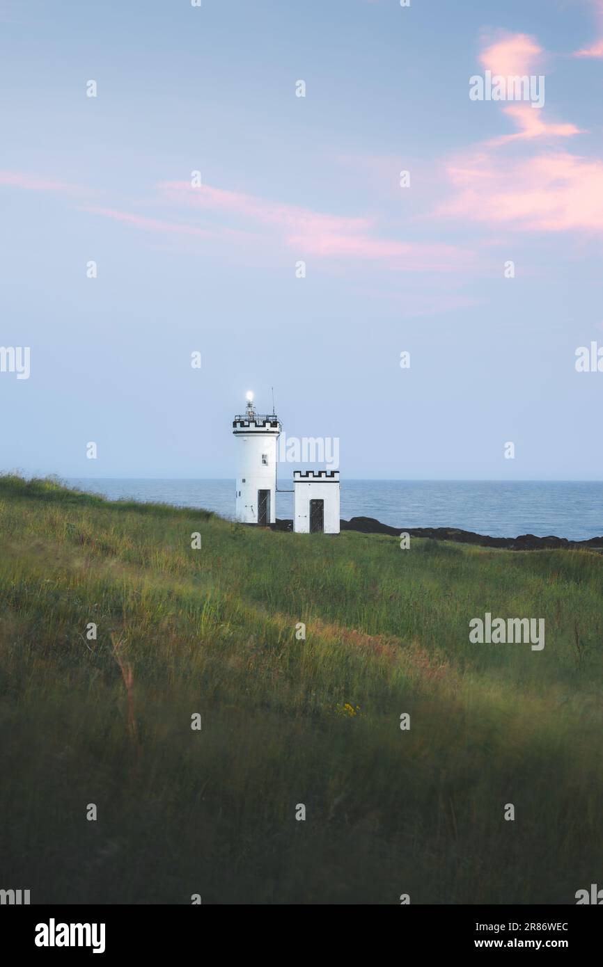 Scenic seascape landscape at dusk of Elie Ness Lighthouse on the East Neuk Peninsula in coastal Fife, Scotland, UK. Stock Photo