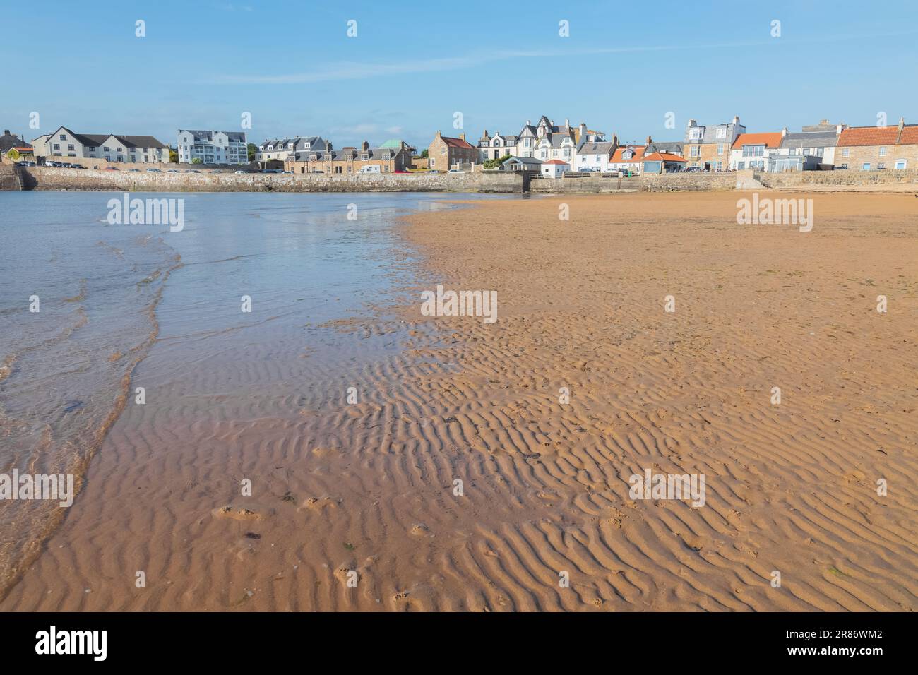Sandy beach and shoreline at low tide in the seaside coastal village of