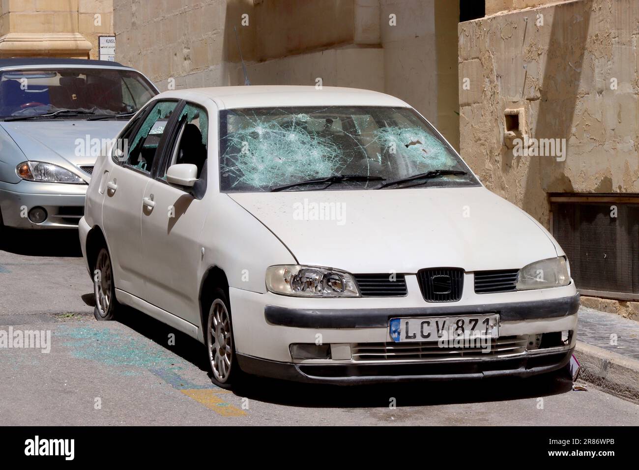 SEAT Cordoba TDi first generation severely vandalised - every window smashed including headlights, and four deflated tyres, Valletta, Malta April 2023. Stock Photo
