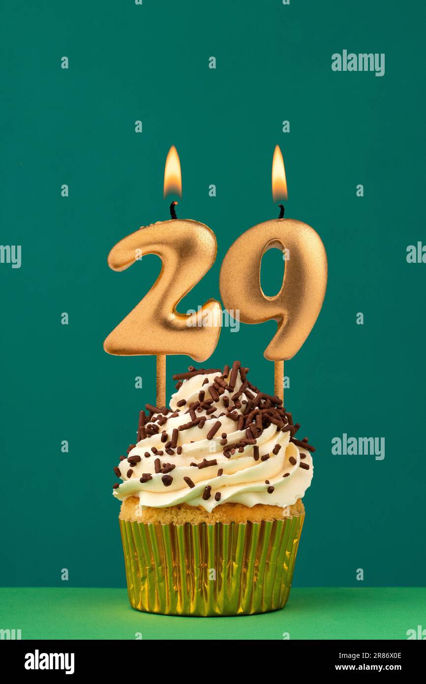 Birthday candle number 29 - Vertical anniversary card with green background Stock Photo