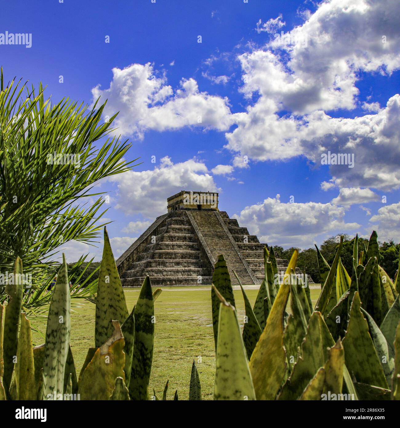 The ancient Chicen Itza ruins under a bright blue sky in Mexico Stock Photo