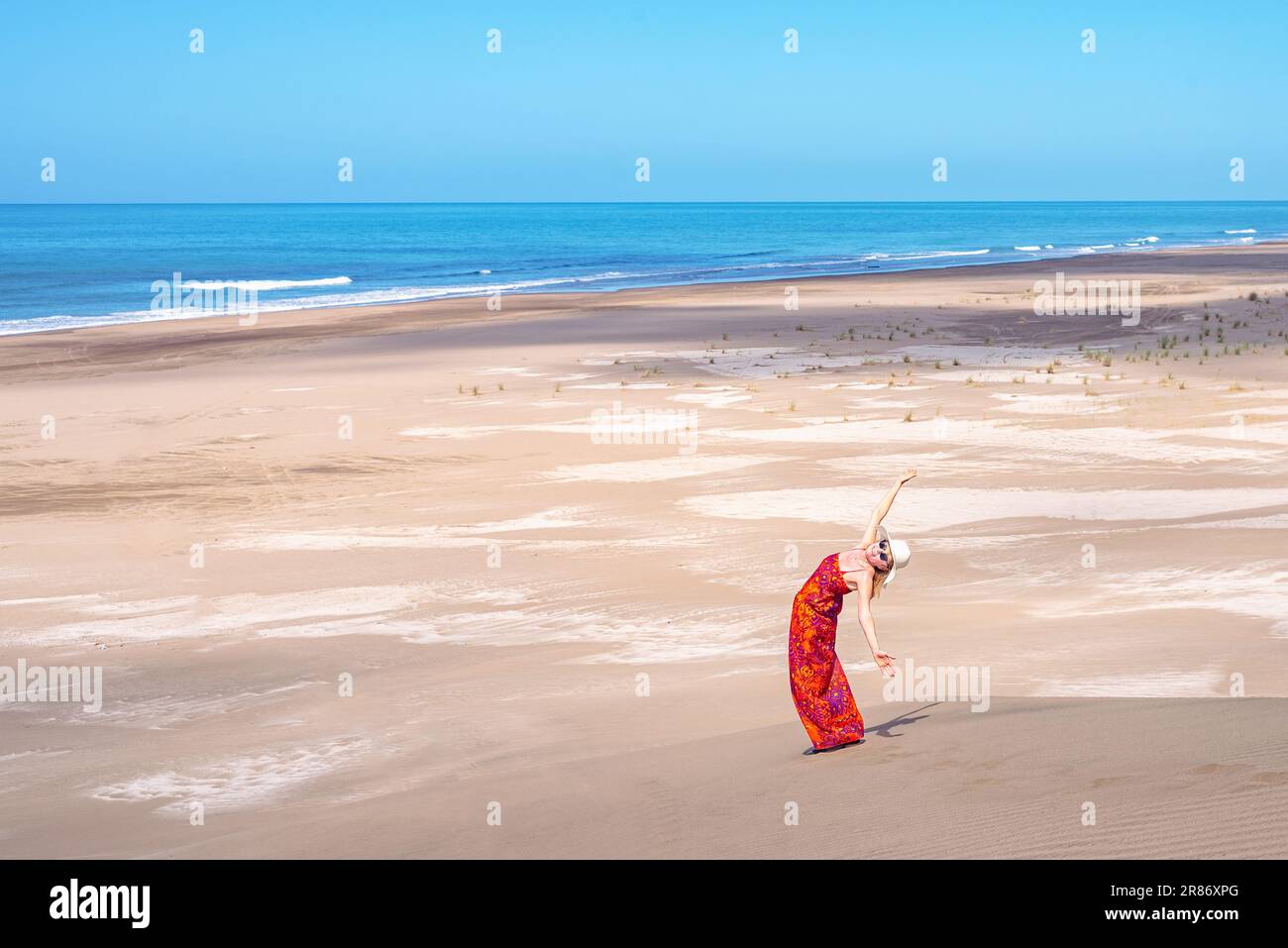Relaxed and happy woman enjoying summer sunny day at the beach. Summer and travel concept. Stock Photo
