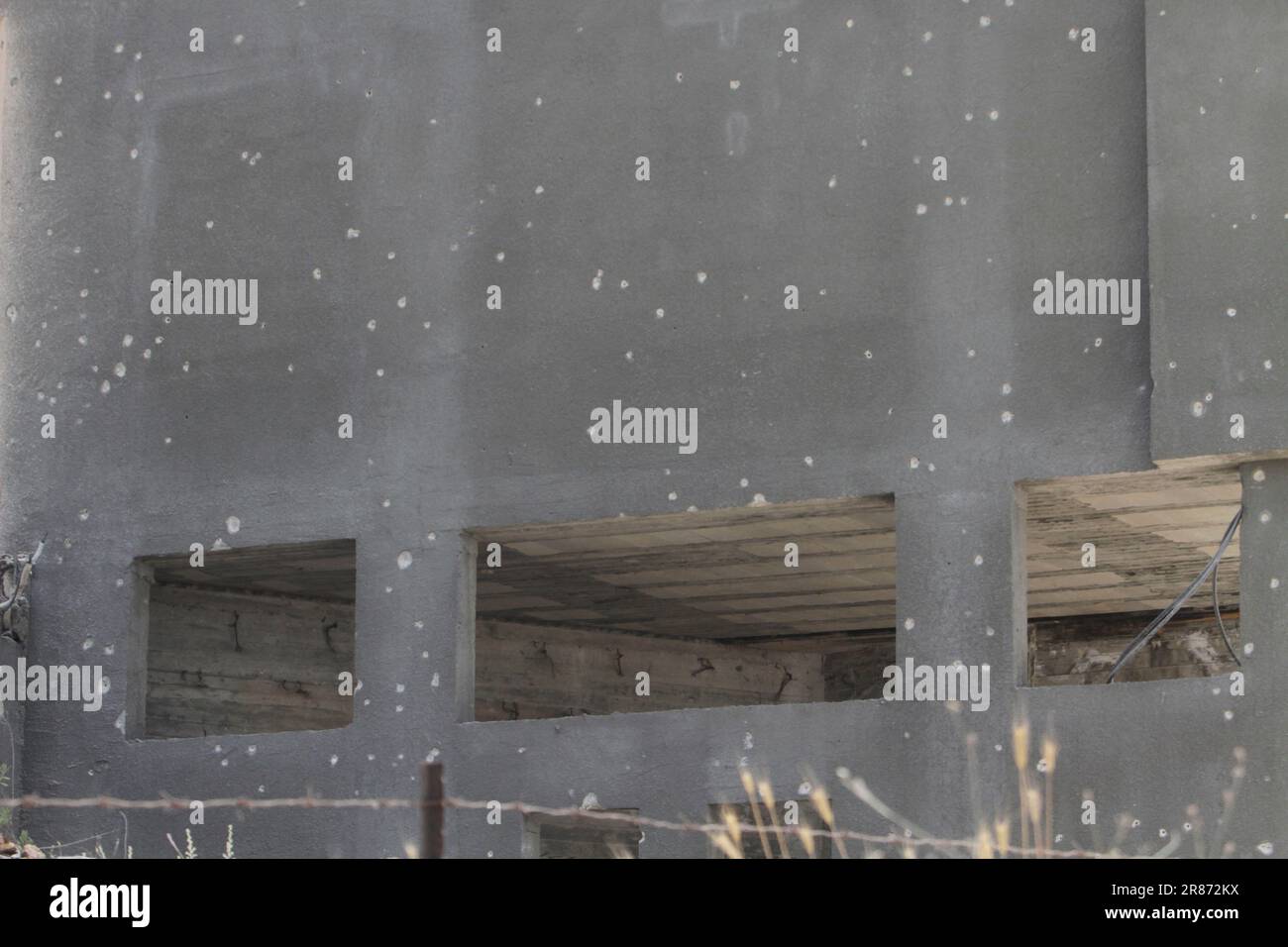 A view of the wall of a house riddled with bullets during a raid on the ...