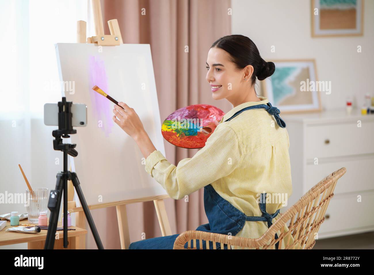 Teacher conducting online painting lesson at home. Time for hobby Stock Photo