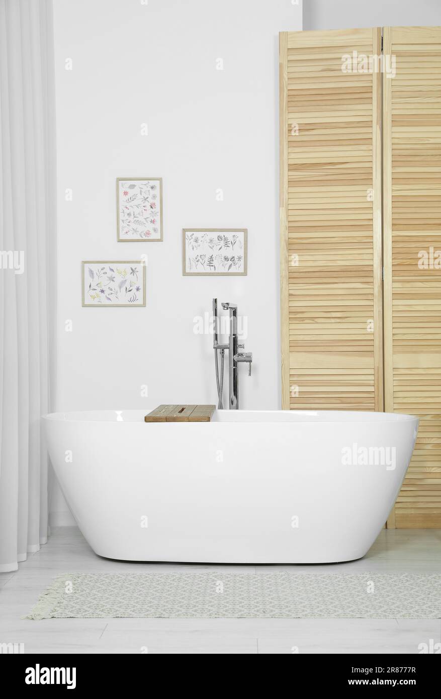 Stylish white tub in bathroom. Interior design Stock Photo - Alamy