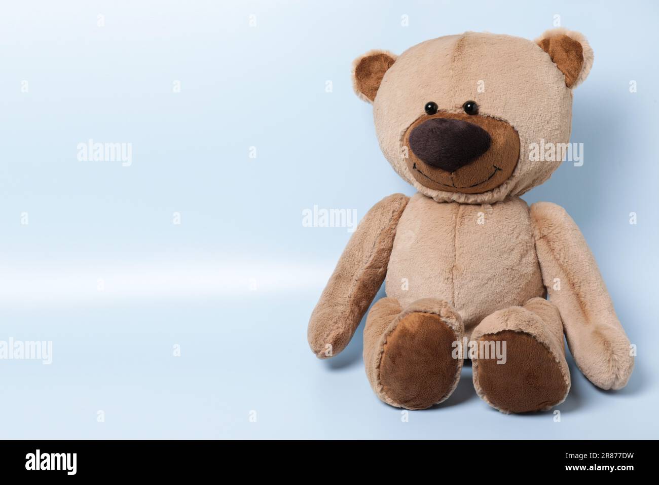 Cute teddy bear on light background, space for text Stock Photo