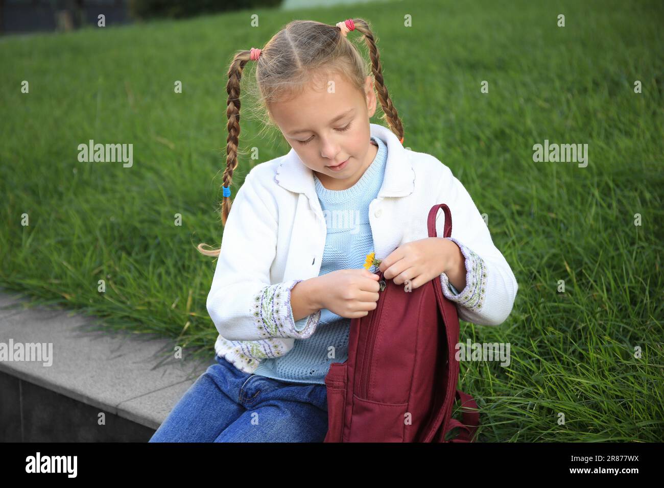 Cute little girl with backpack on city street Stock Photo - Alamy