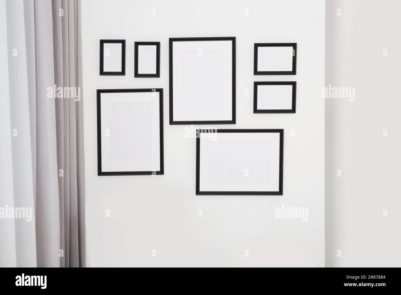Empty frames hanging on white wall indoors Stock Photo Alamy