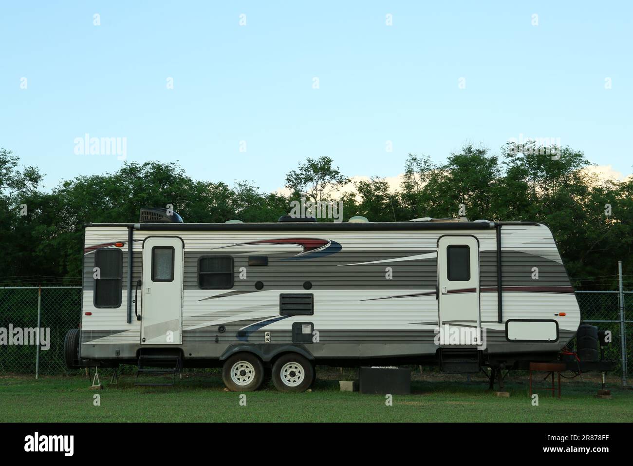 Travel trailer parked outdoors. Home on wheels Stock Photo