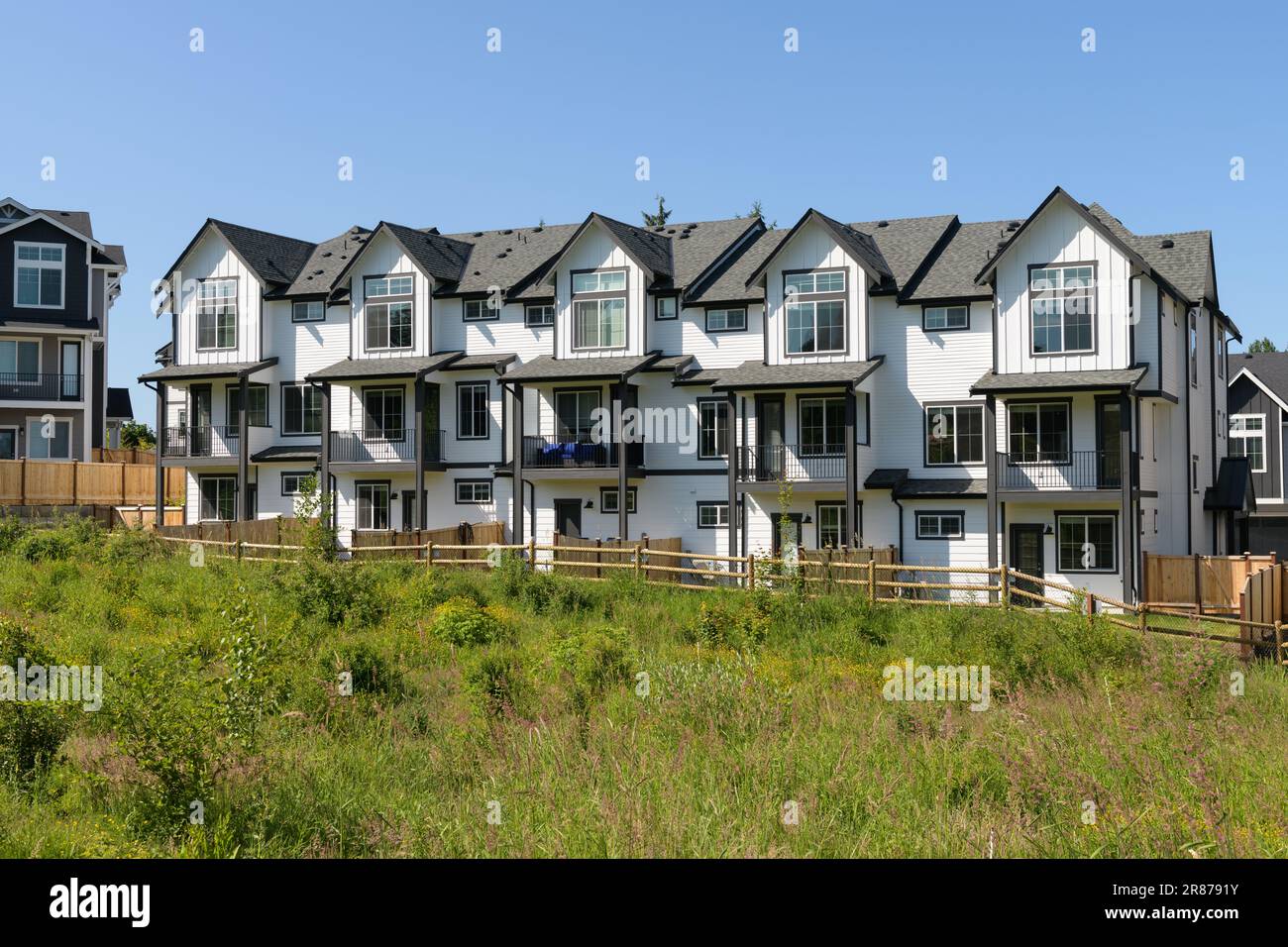 Duvall, WA, USA - June 04, 2023; Row of new construction  townhomes with native growth area in Duvall WA Stock Photo
