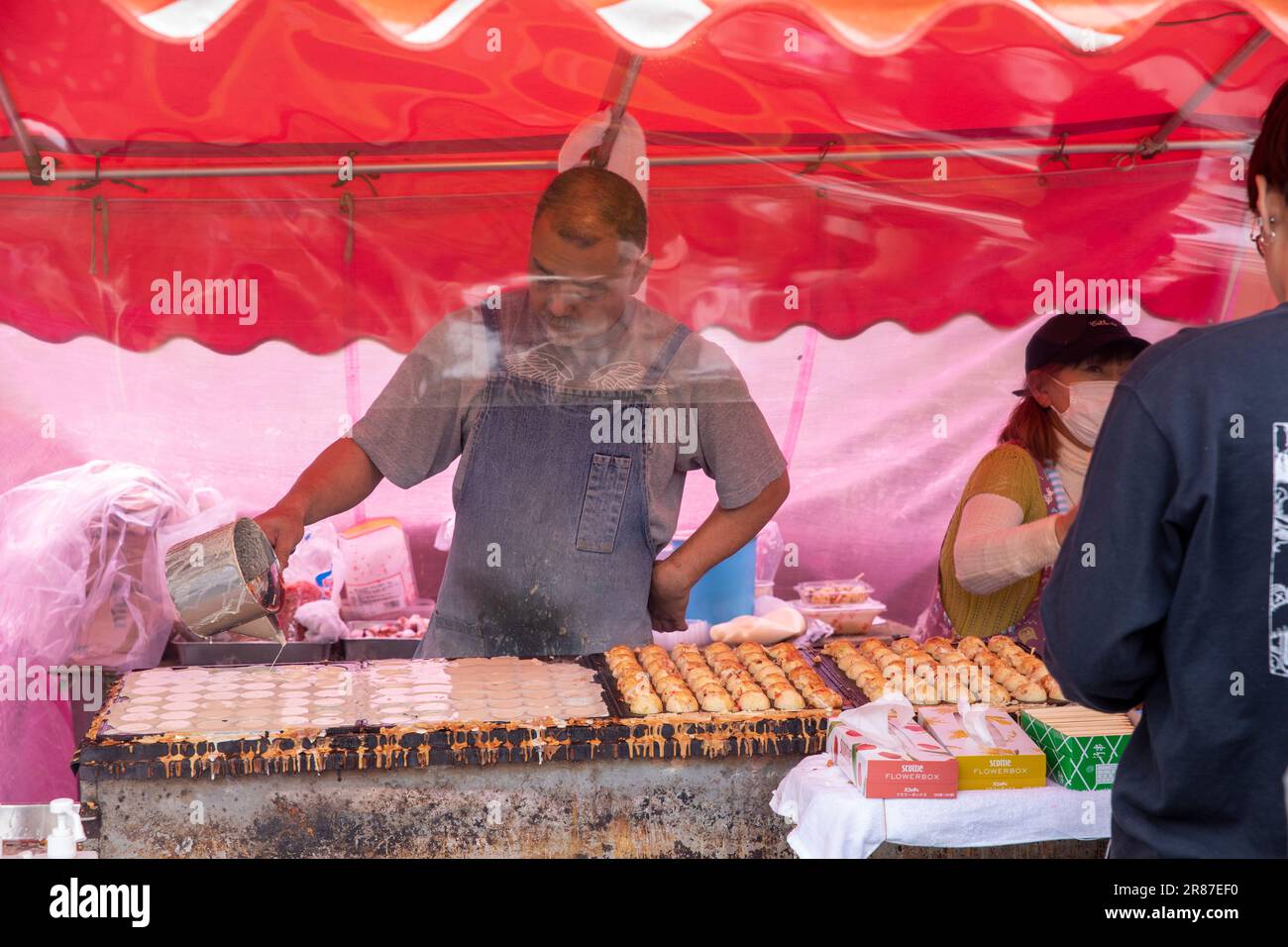 Japanese food stall and chef cooking and serving octopus balls Takoyaki, at Sensoji temple in Asakusa,Tokyo,Japan,Asia 2023 Stock Photo