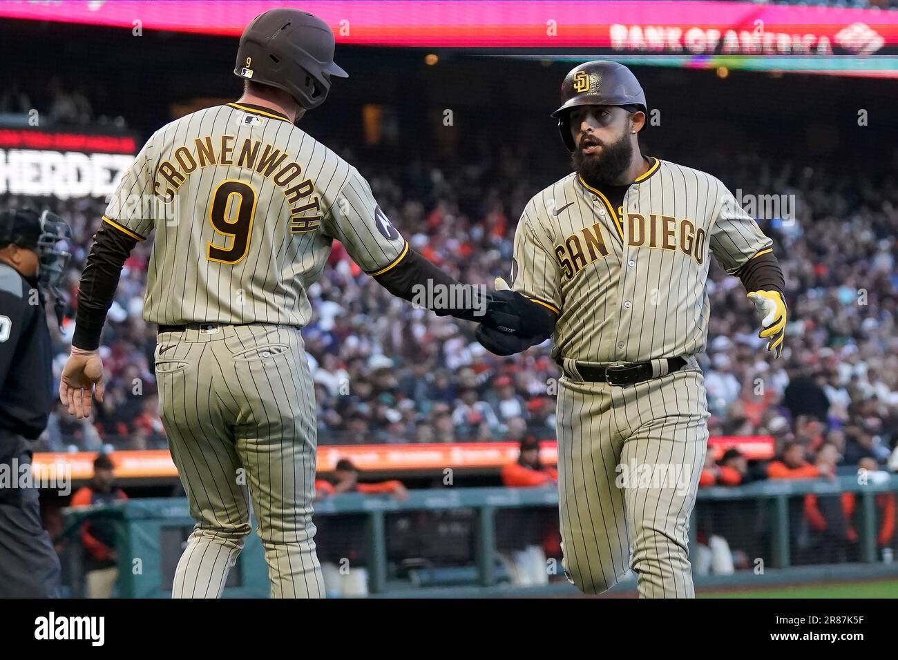 San Diego Padres' Jake Cronenworth (9) celebrates with Rougned Odor after  they scored on a two-run single hit by Ha-Seong Kim during the fourth  inning of a baseball game against the San