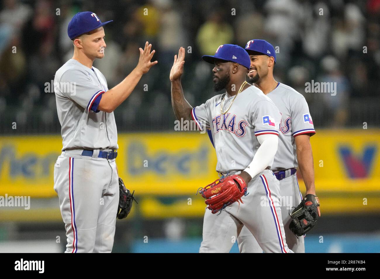 Texas Rangers' Corey Seager, left, Adolis Garcia, center, and Marcus Semien  celebrate the team's 5-2 win over the Chicago White Sox after a baseball  game Monday, June 19, 2023, in Chicago. (AP