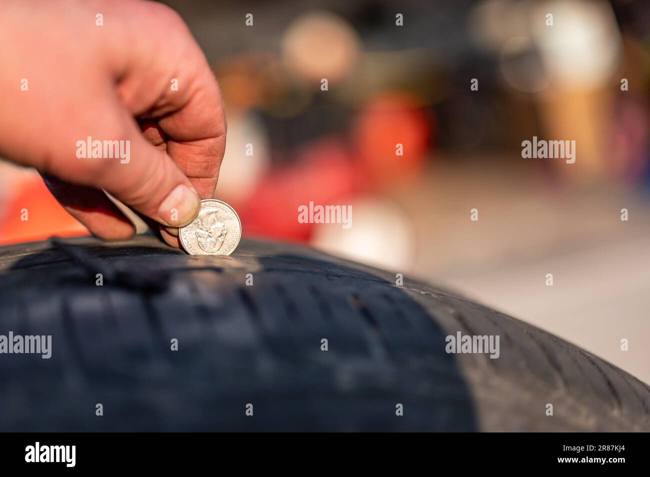 Quarter test on a tire to check wear by seeing the tread depth Stock