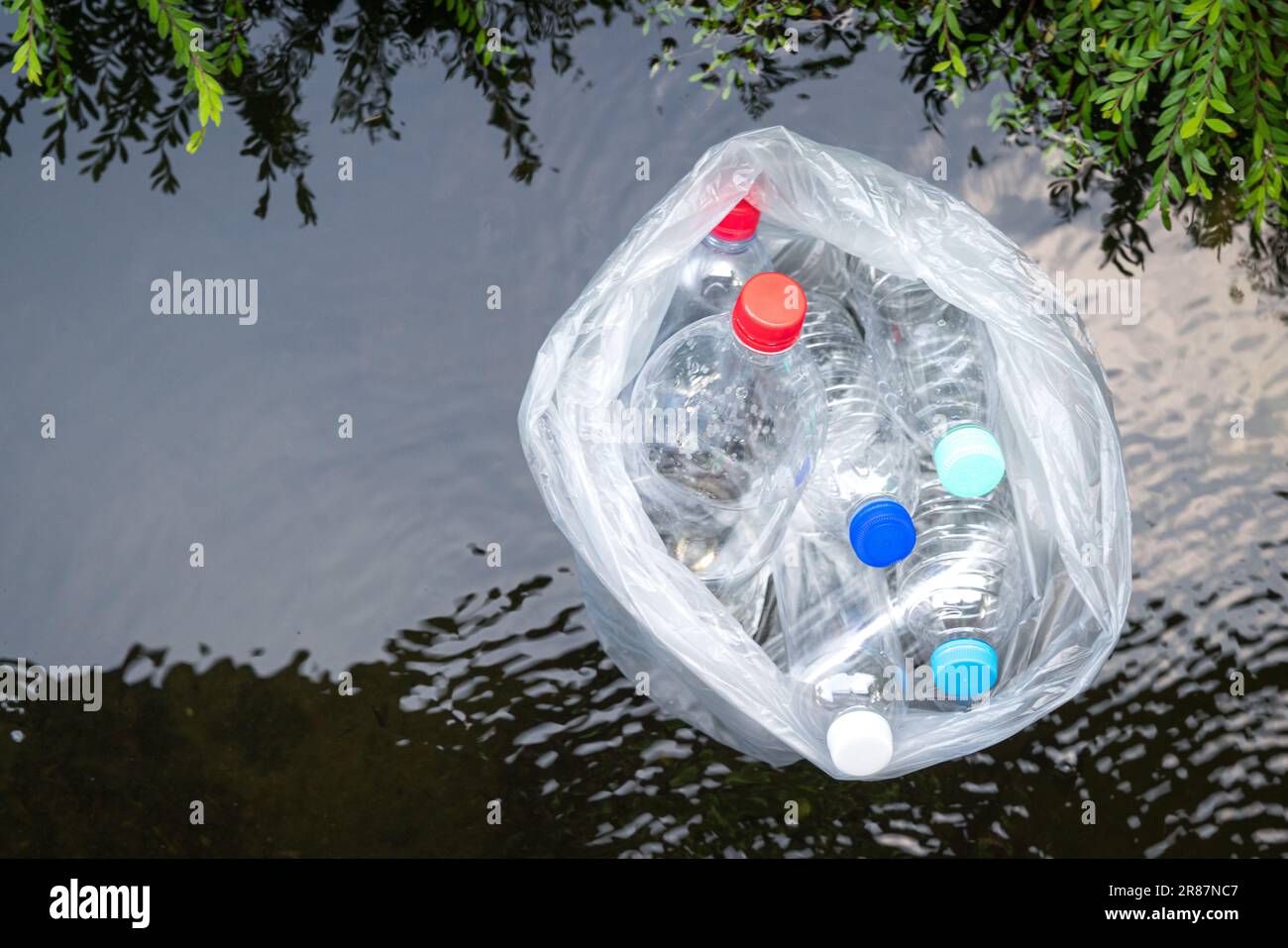 Plastic bottles floating on water surface. Top view. Pollution or trash ...