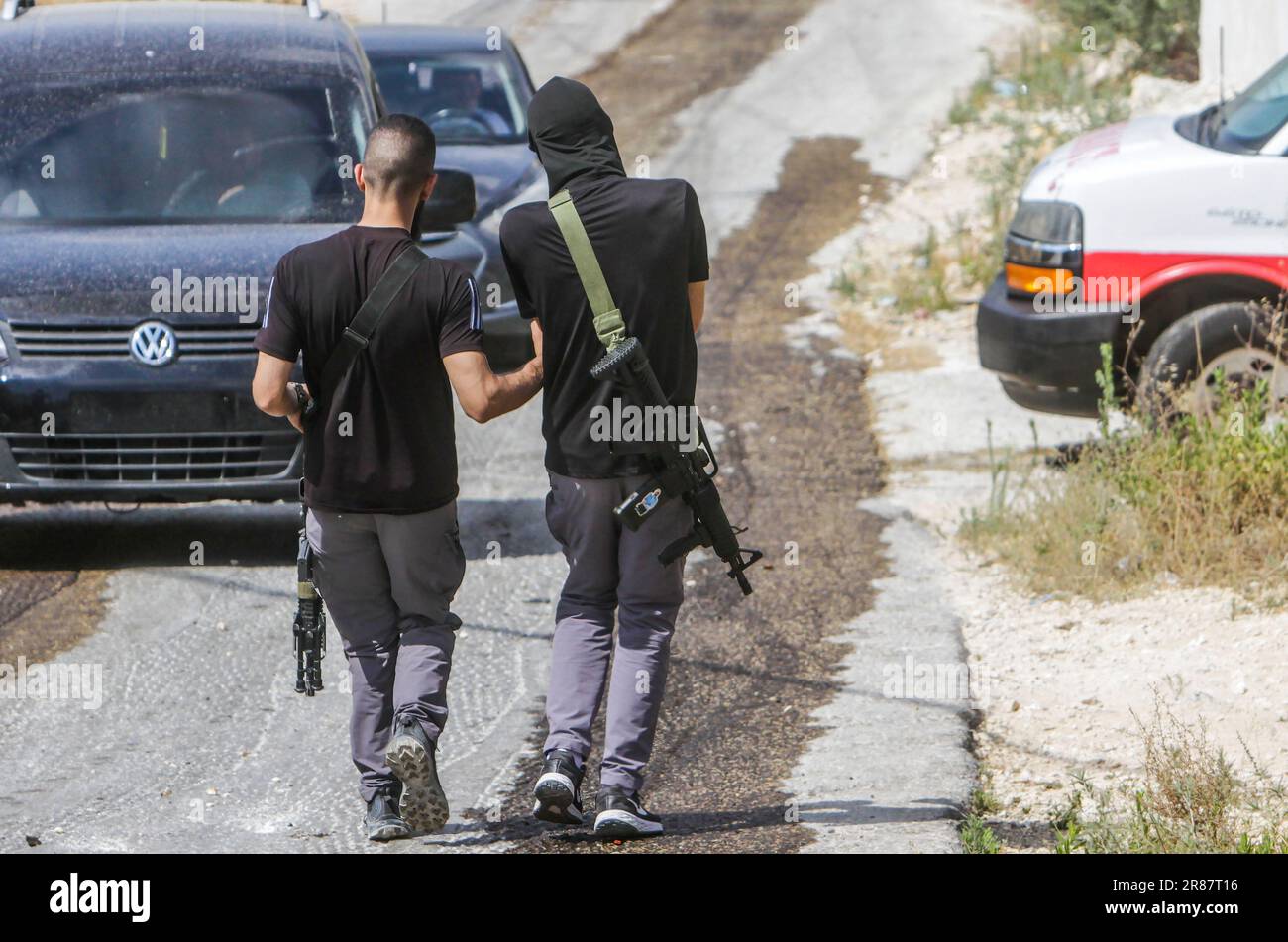 Jenin, Palestine. 19th June, 2023. Two Palestinian gunmen seen during a raid on the Jenin camp in the northern occupied West Bank. Israeli army forces raided the Jenin refugee camp near the city of Jenin with helicopters and dozens of armored military vehicles.  The Palestinian resistance fighters installed a homemade device that exploded under an Israeli military vehicle, which destroyed it, injuring seven Israeli soldiers who were inside. Credit: SOPA Images Limited/Alamy Live News Stock Photo