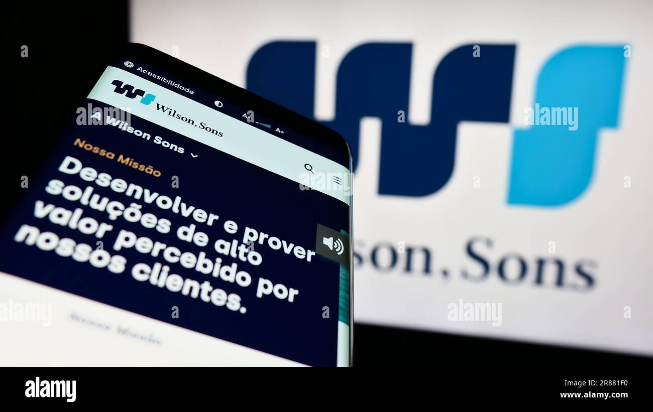 Smartphone with website of Brazilian logistics company Wilson Sons S.A. on screen in front of