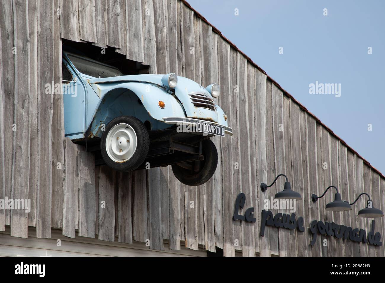 Bordeaux , Aquitaine  France - 06 06 2023 : citroen 2cv car front hanging in store restaurant facade wall decoration french classic car in city france Stock Photo