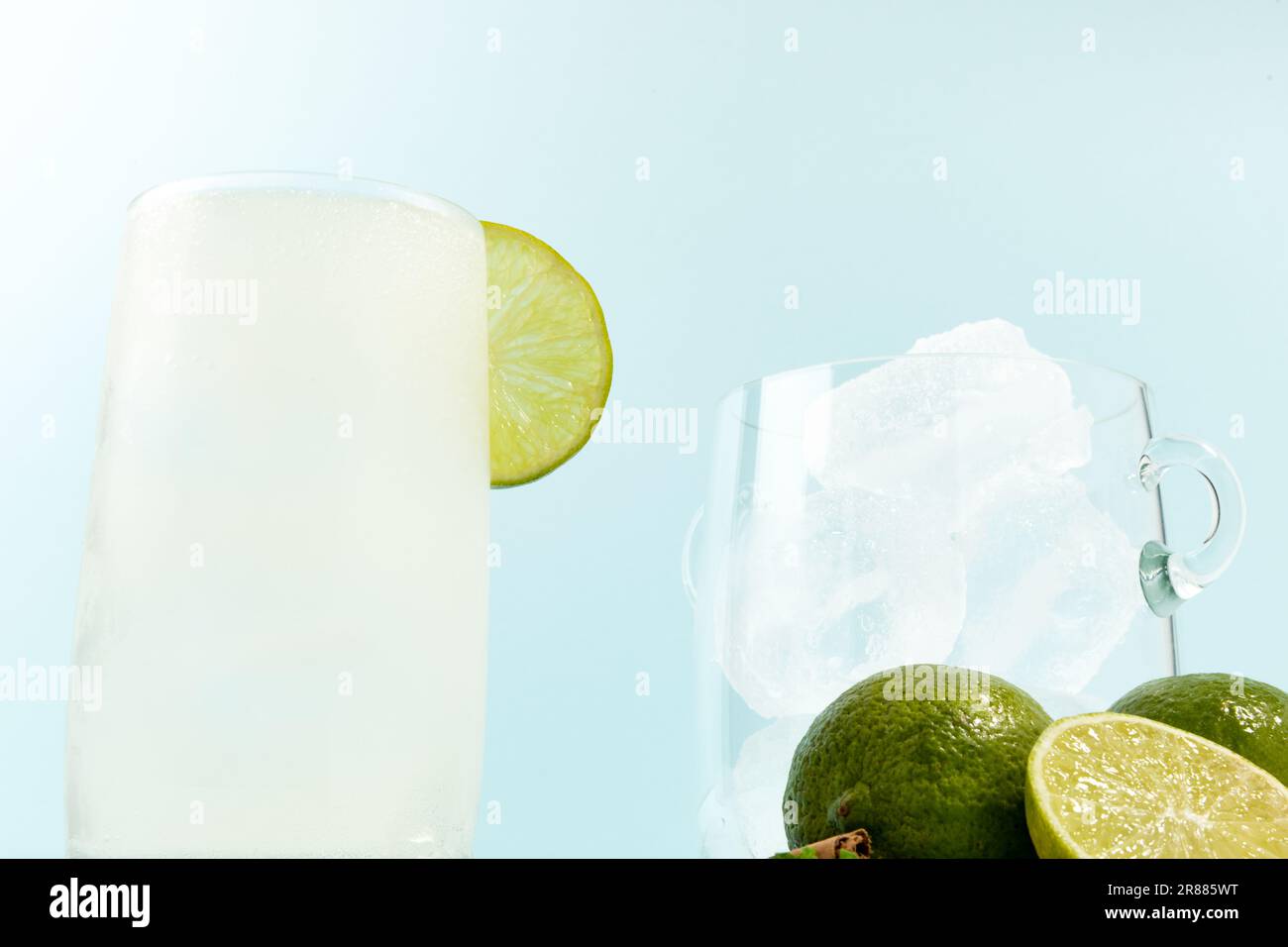 Summer refreshing lemonade drink or alcoholic cocktail on bright cyan ...