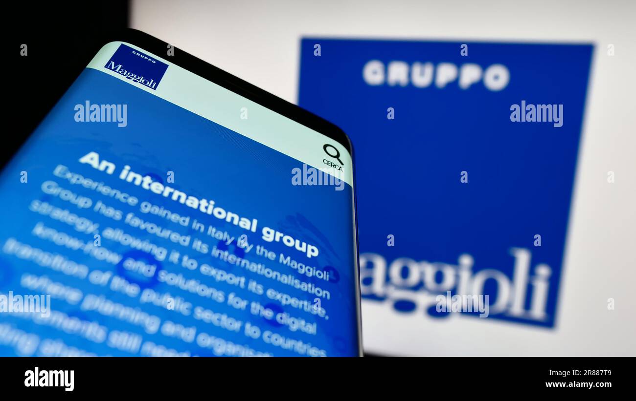 Smartphone with website of information technology company Maggioli SpA on screen in front of business logo. Focus on top-leftof phone display. Stock Photo
