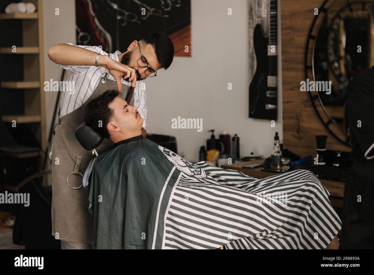Process of threading procedure in barber shop. Professional barber