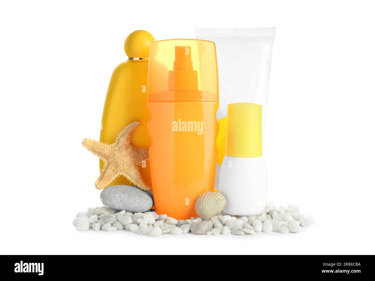Different suntan products, seashell, starfish and stones on white