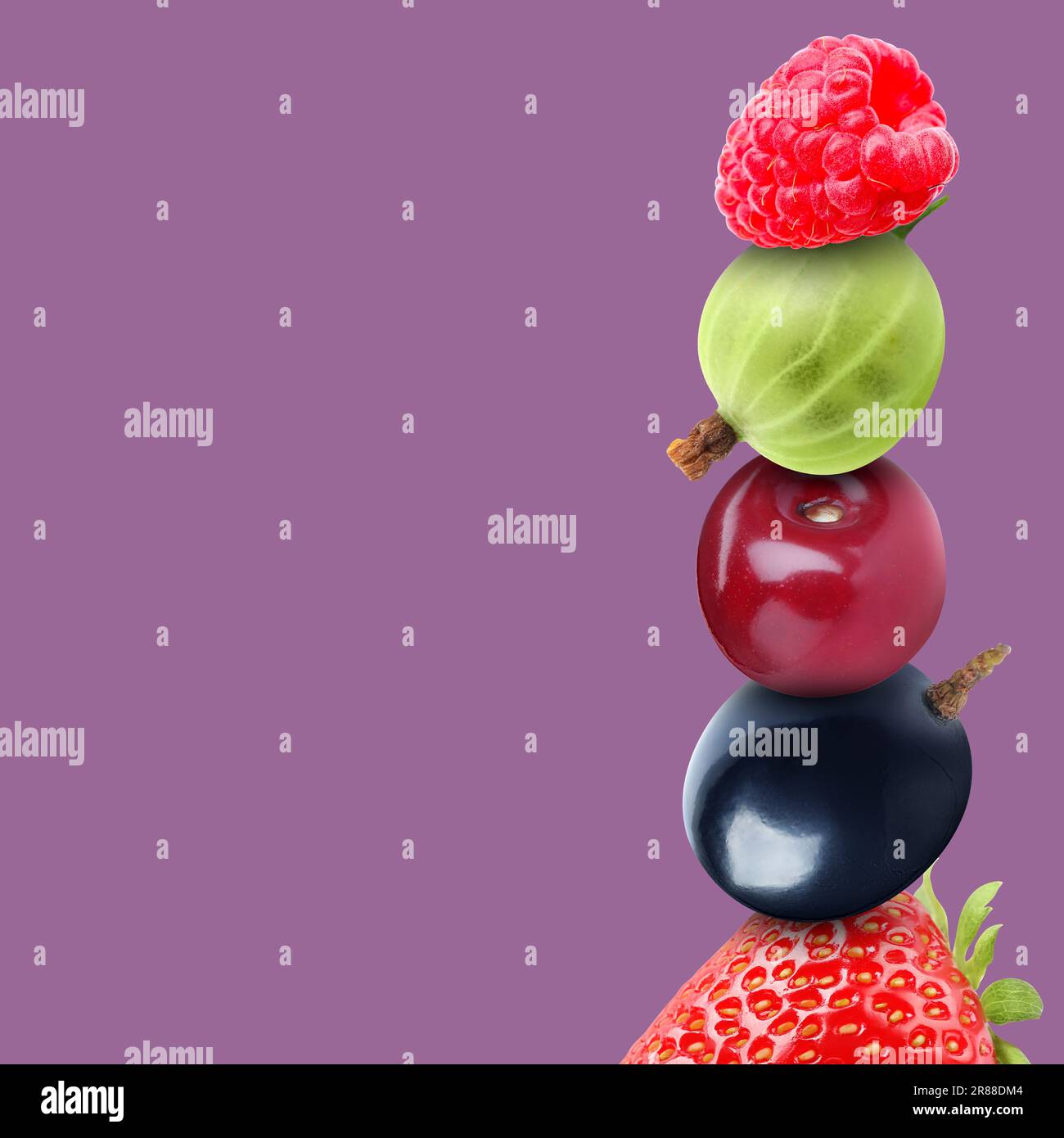 Stack of different fresh tasty berries and cherry on pale purple ...
