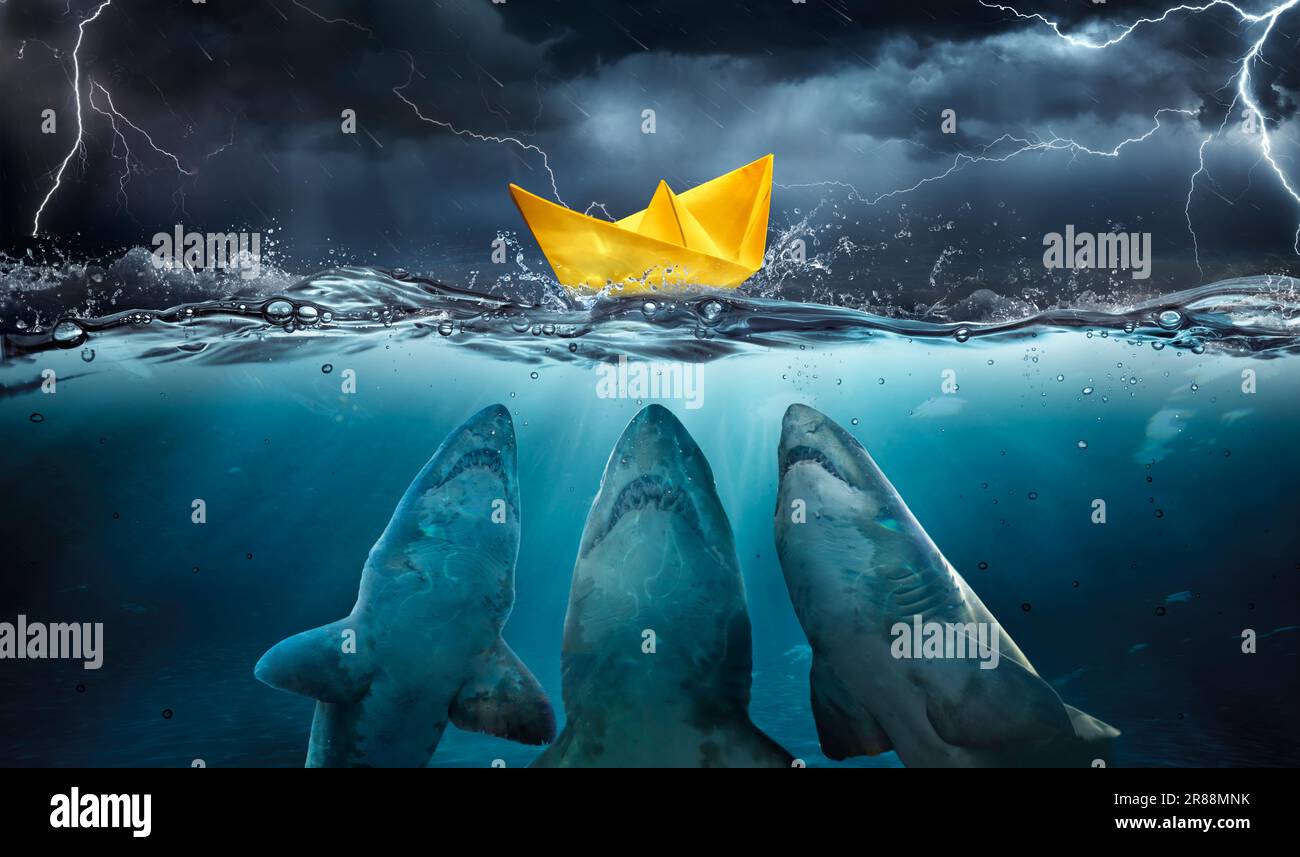 Paper Boat At Risk Whit Sharks In Water And Sea In Storm Stock Photo