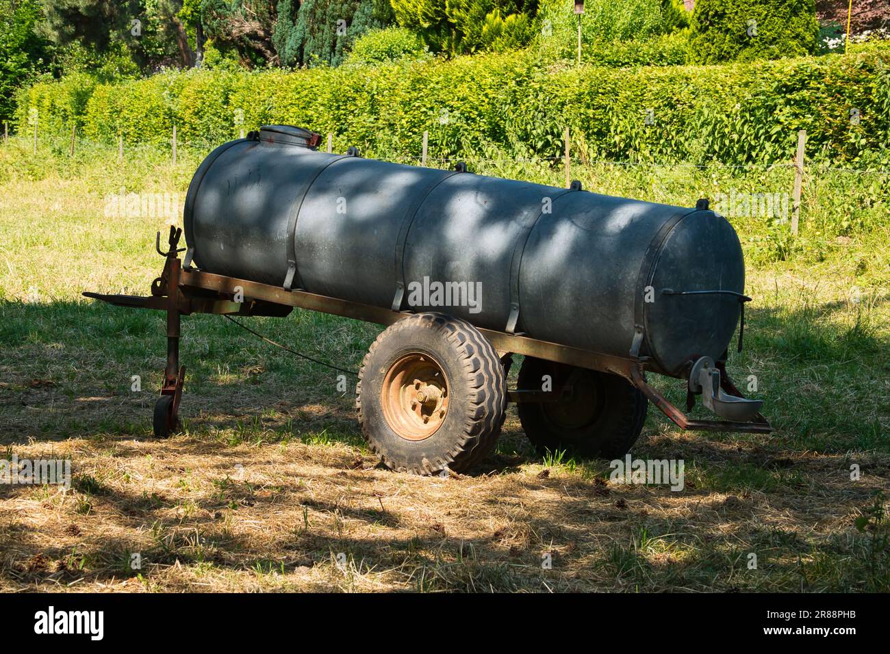 A mobile water trough for animals on a green meadow Stock Photo Alamy