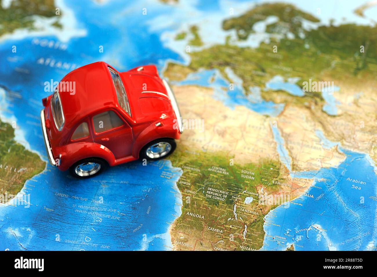 red toy car on a map, concept for traveling in Africa Stock Photo