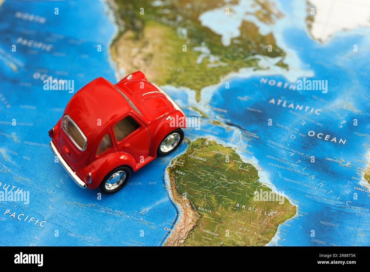 red toy car on a map, concept for traveling in America continent Stock Photo