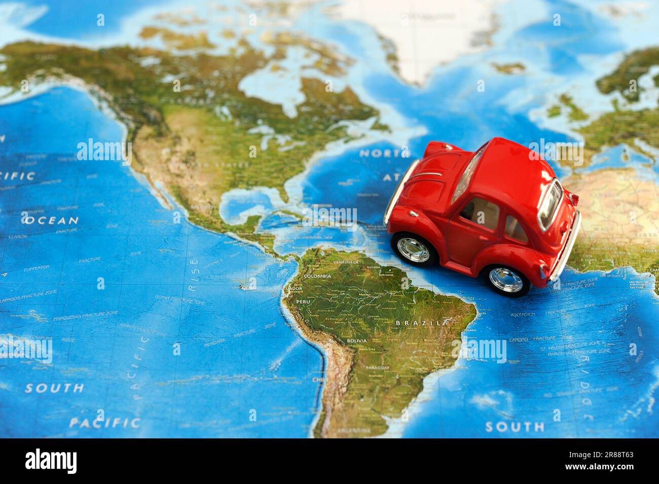 red toy car on a map, concept for traveling in America continent Stock Photo