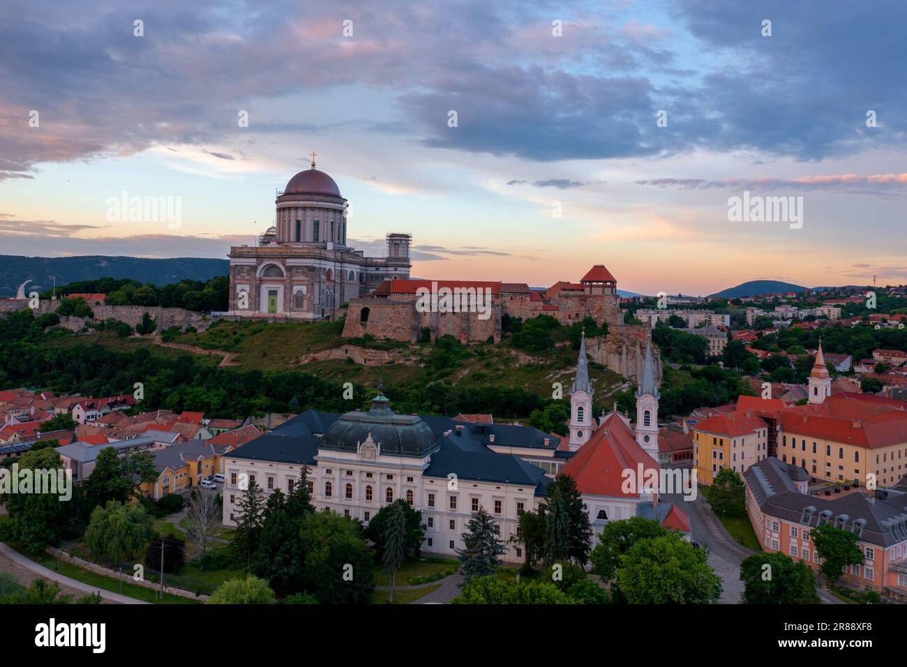 Aerial skyline view about the Castle of Esztergom with the famous Basilica and cloudy sunset at the background Stock Photo