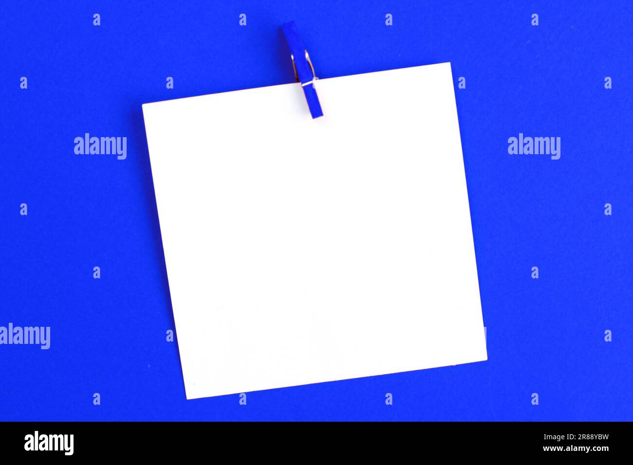 sticker with empty mockup for your text hanging on the pin on blue ...