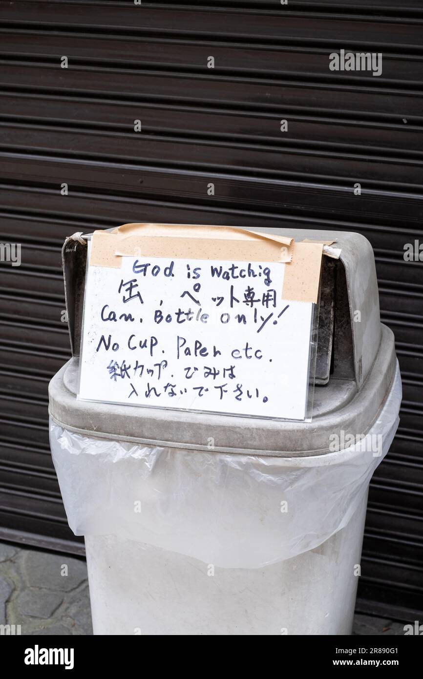 Bin with a sign saying 'God is watching, Can, Bottle only! No Cup