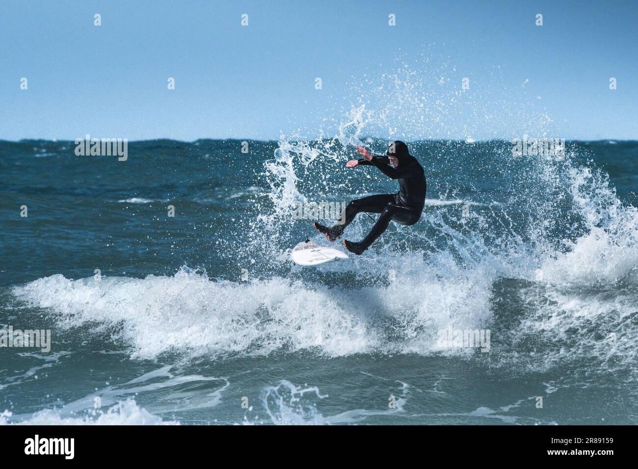 A surfer wiping out surfing at Fistral in Newquay in Cornwall in the UK. Stock Photo