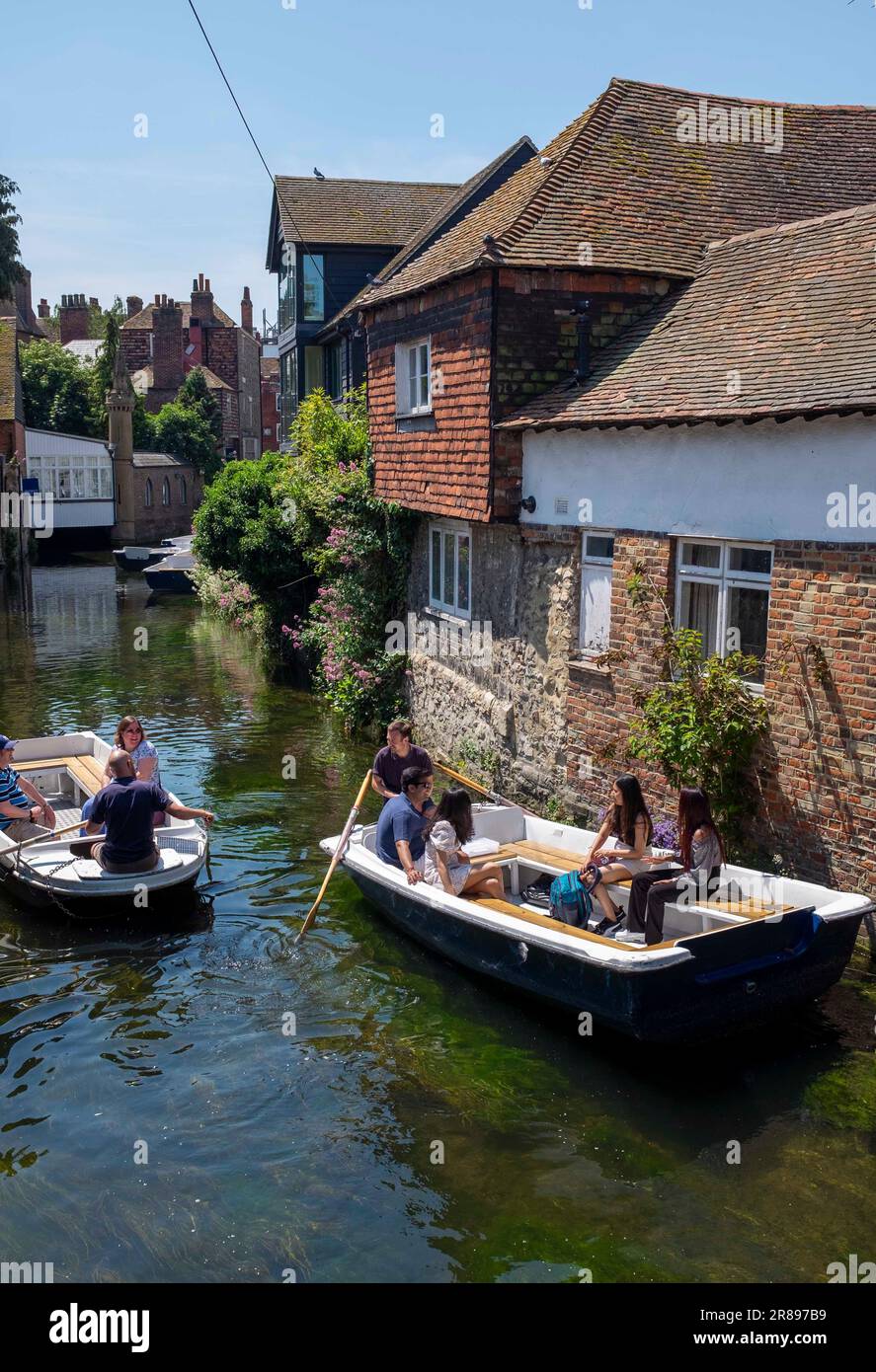 Canterbury , Kent , England UK - Tourist punt and boats on the River Stour in the city centre on a beautiful hot summers day Stock Photo