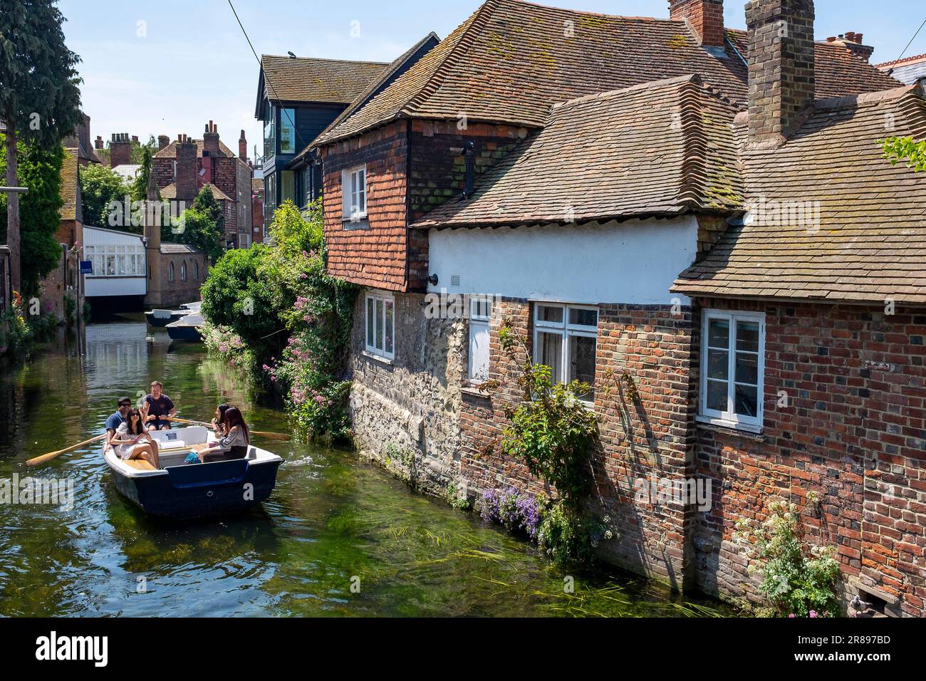 Canterbury , Kent , England UK - Tourist punt and boats on the River Stour in the city centre on a beautiful hot summers day Stock Photo