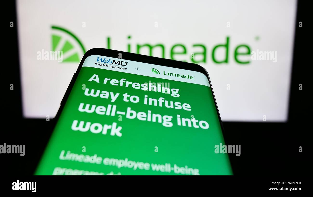 Mobile phone with website of US employee well-being company Limeade Inc. on screen in front of business logo. Focus on top-left of phone display. Stock Photo