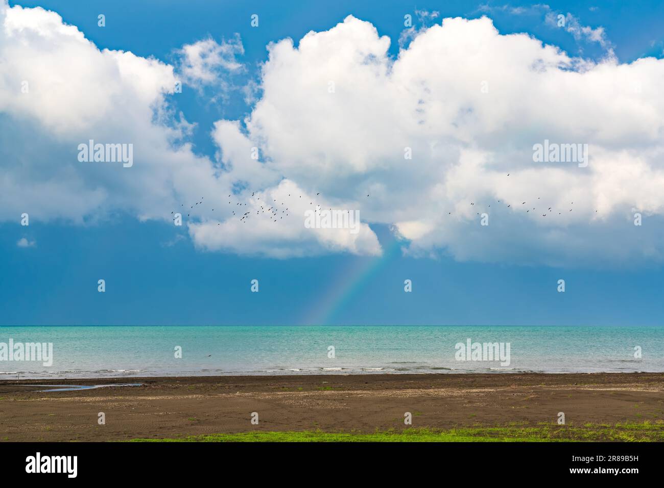 Rainbow after the rain over the sea Stock Photo - Alamy