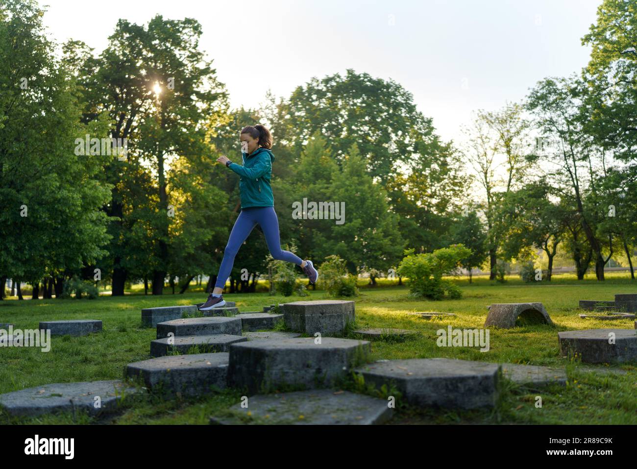 Happy sporty woman jumping hi-res stock photography and images - Alamy