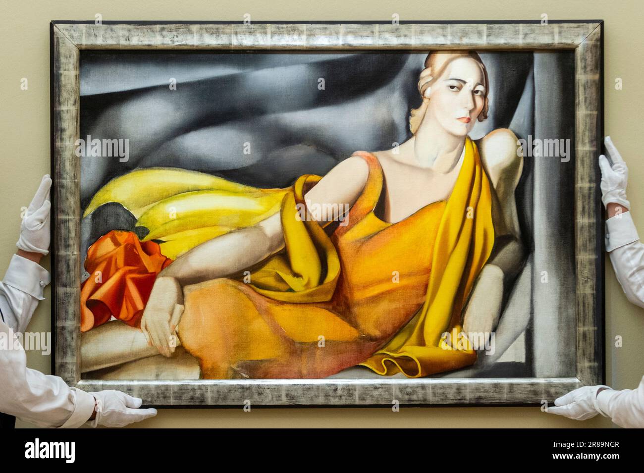 London, UK.  20 June 2023. Technicians present ‘Femme à la robe jaune’, 1929, by Tamara de Lempicka (Est. £2.5-3.5 million) at a preview of highlights from Sotheby’s summer sales.  The works will be auctioned at the Now and Modern & Contemporary Evening Auctions at Sotheby’s New Bond Street galleries on 27 June.  Credit: Stephen Chung / Alamy Live News Stock Photo