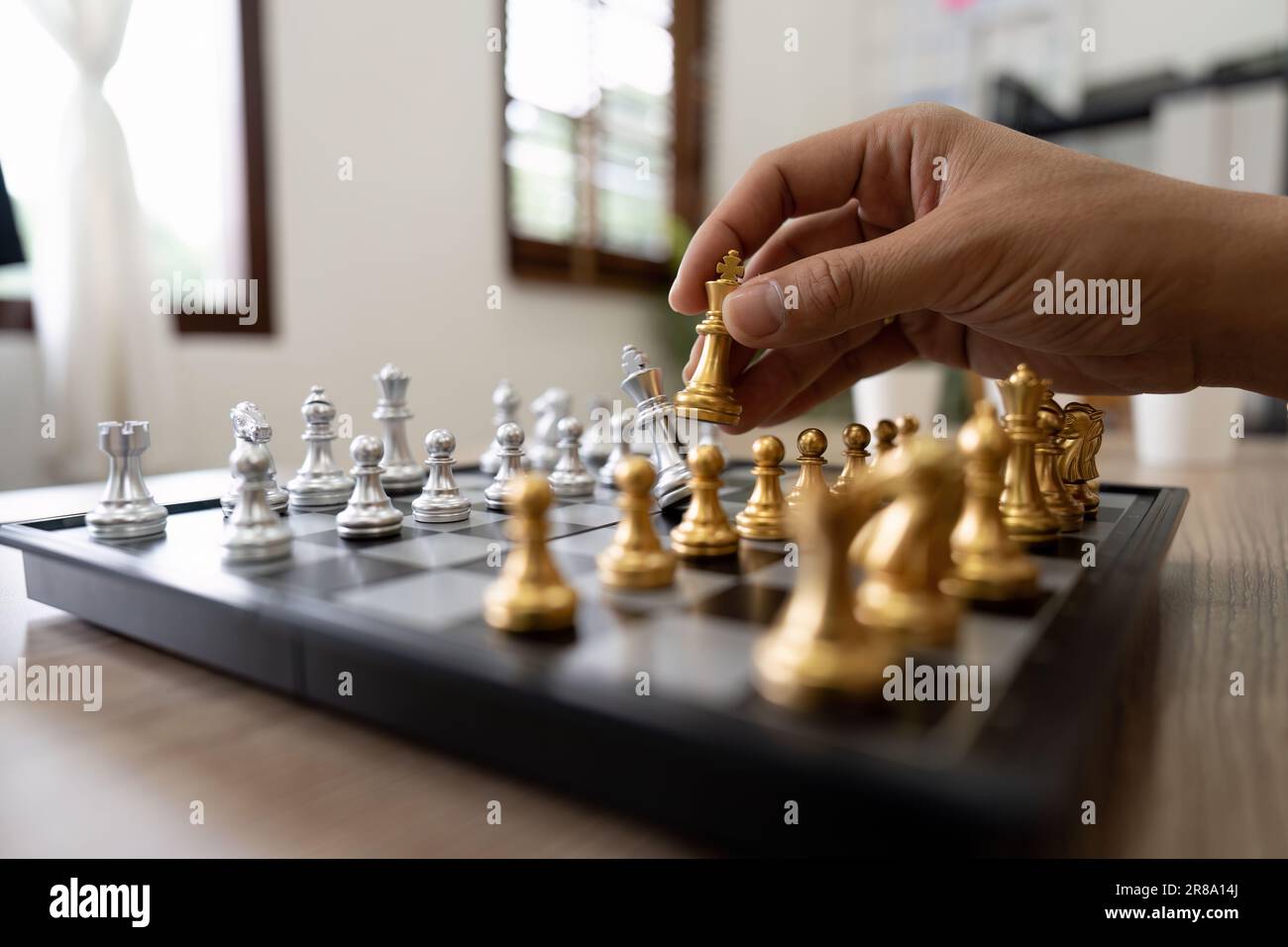 One arab businessman checkmates another playing chess at table at