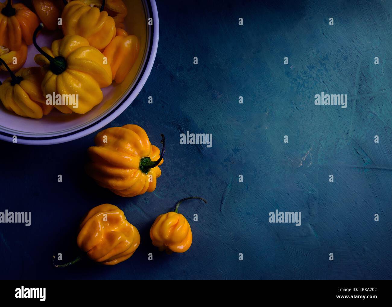 fresh yellow peppers on blue background Stock Photo