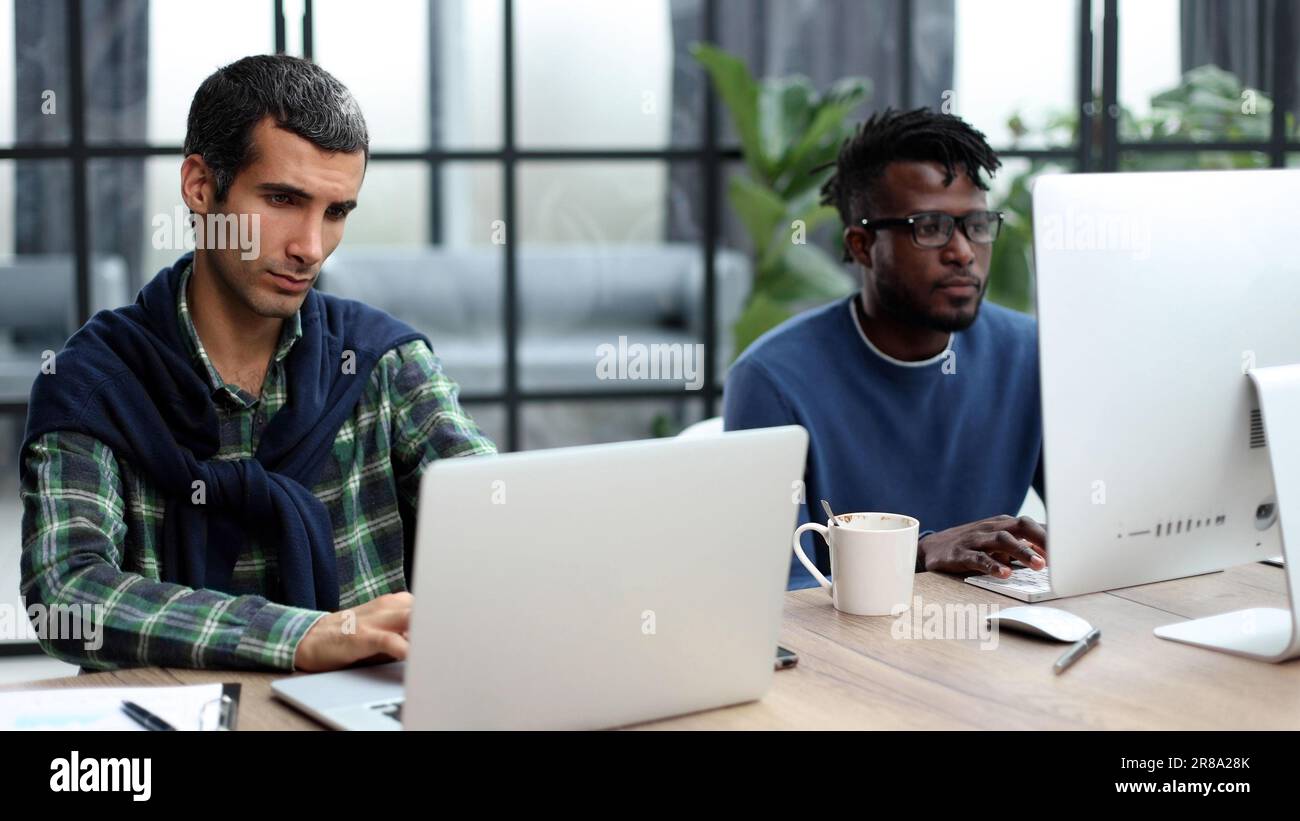 Young multiethnic businessmen working at the negotiating table Stock Photo
