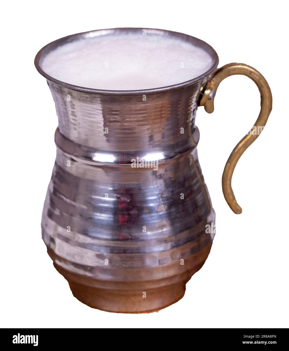 Buttermilk isolated on white background. Sparkling buttermilk in an iron glass. Beverage