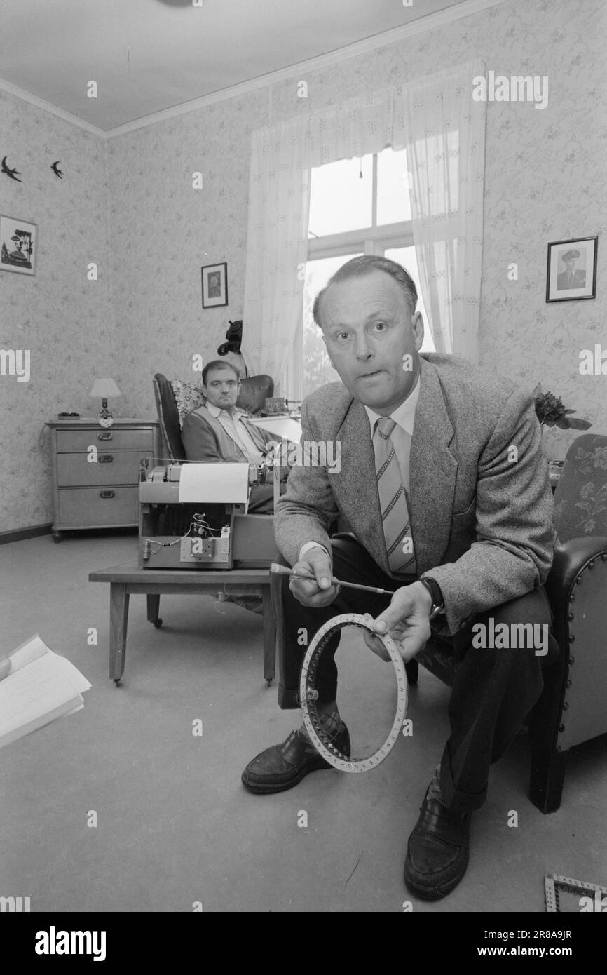 Actual 27-9-1960: He writes with his lips Torbjørn Brovold, aged 41, is probably the only completely paralyzed person in the world who types. He can't move his body, arms or legs, - only his head - but still he runs a depreciation agency. He produces transcripts on a continuous basis – wedding songs, advertising letters with a personal touch, business letters etc. The writings he carries out for his clients are neatly and beautifully laid out, without a typo and with absolutely even strokes. His friend, Arne Sesseng (front), who has electrical engineering as a hobby, has built the remote contr Stock Photo