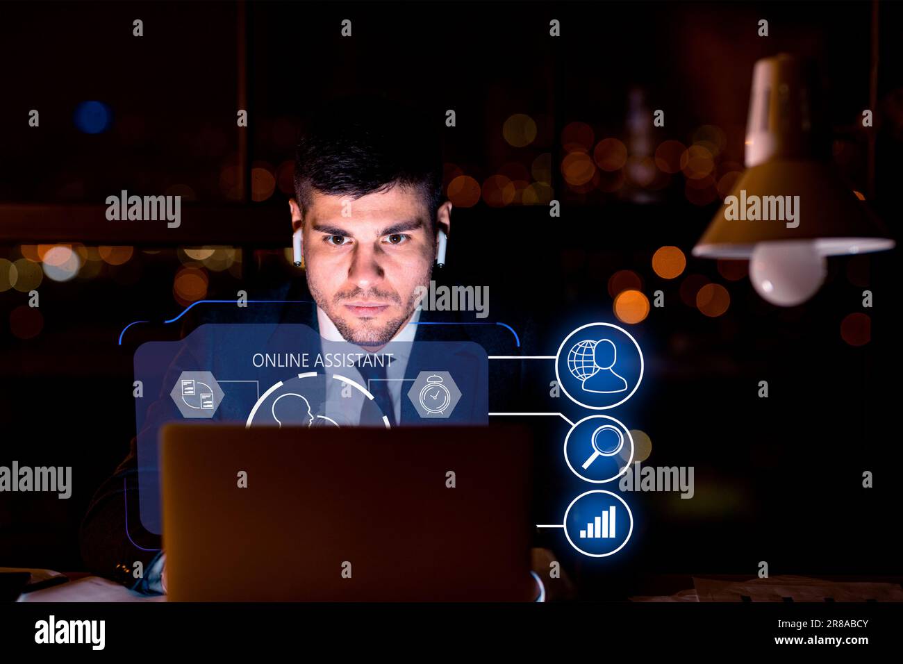Young man wearing suit working on laptop, using chatbot Stock Photo