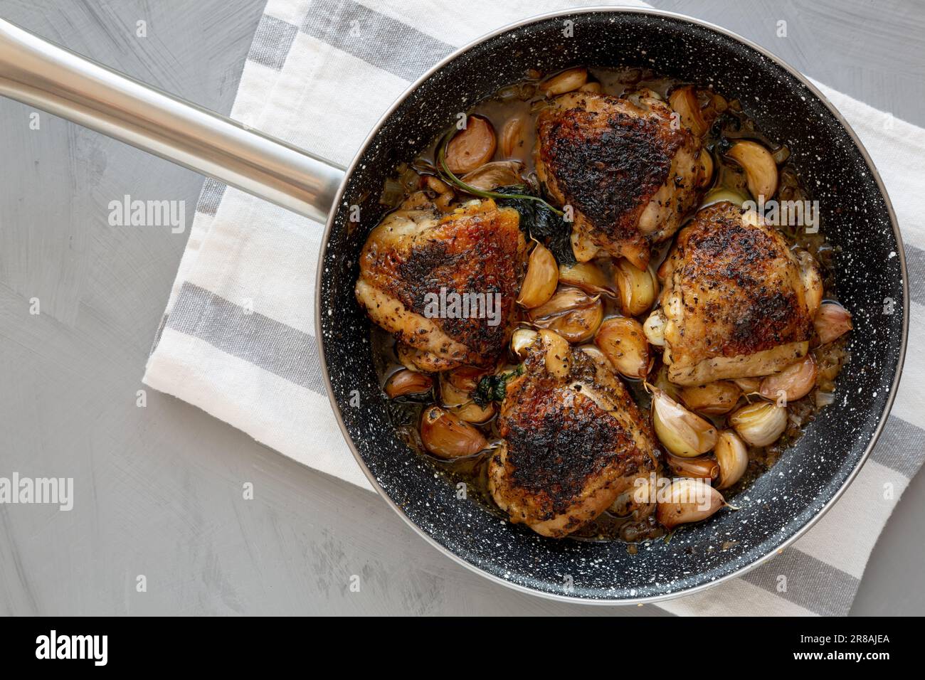 Homemade Chicken With 40 Cloves of Garlic on a Plate, top view. Flat lay, overhead, from above. Stock Photo