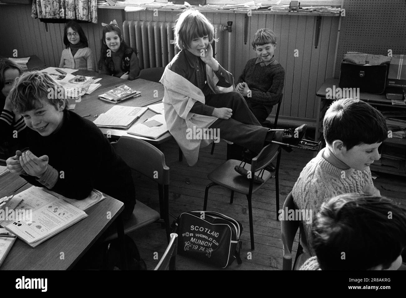 Junior school, schoolboys and schoolgirls in class. Disabled schoolgirl